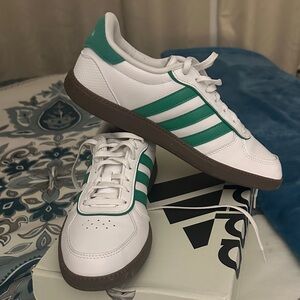 Adidas White and green striped sneakers.